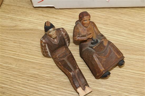 A Black Forest Bear string puppet, various Russian dolls and two carved figures